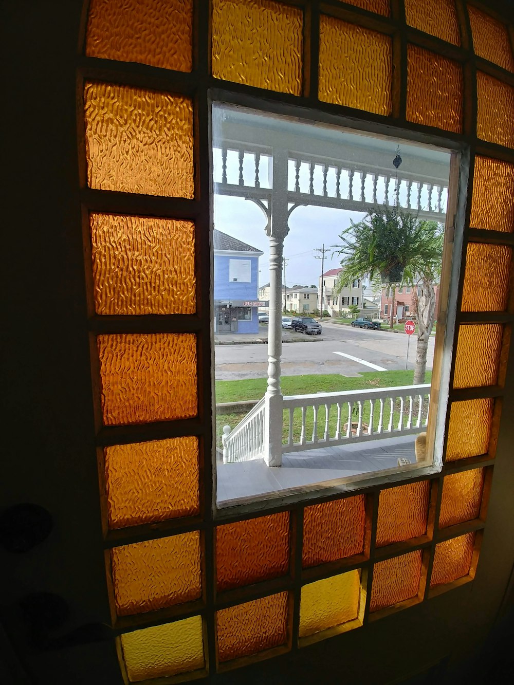 a view of a street through a stained glass window