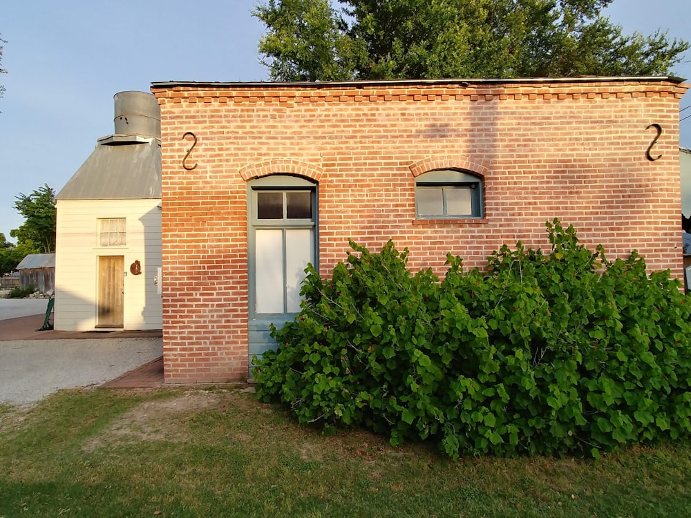 a brick building with a white door and window