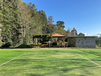 Open outdoor training area surrounded by greenery and blue skies.