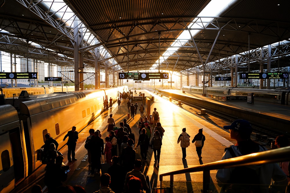 a group of people standing on a platform next to a train