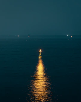 a full moon shines brightly on the water