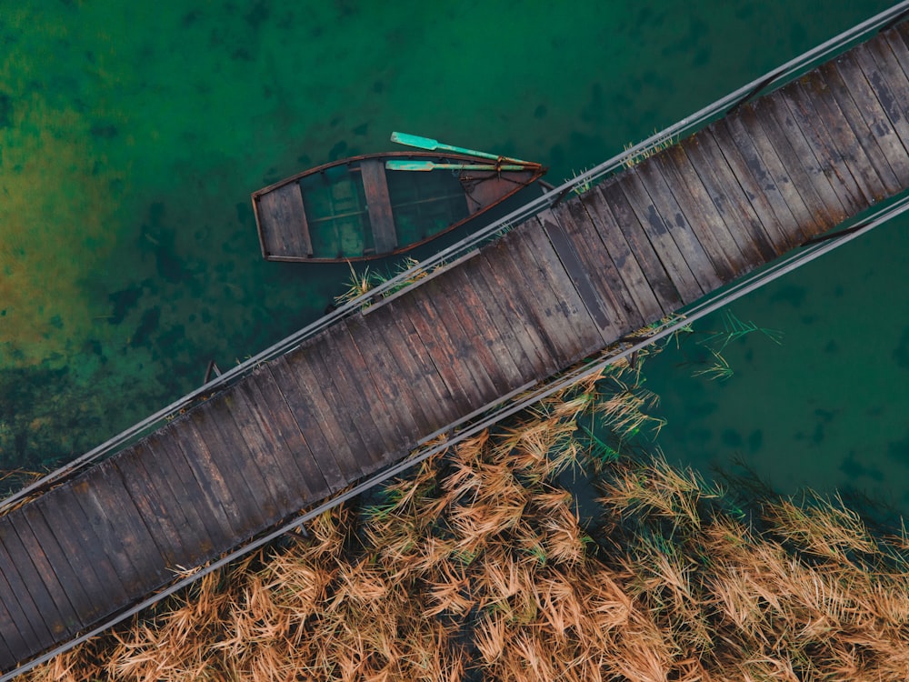 a boat sitting on top of a wooden dock