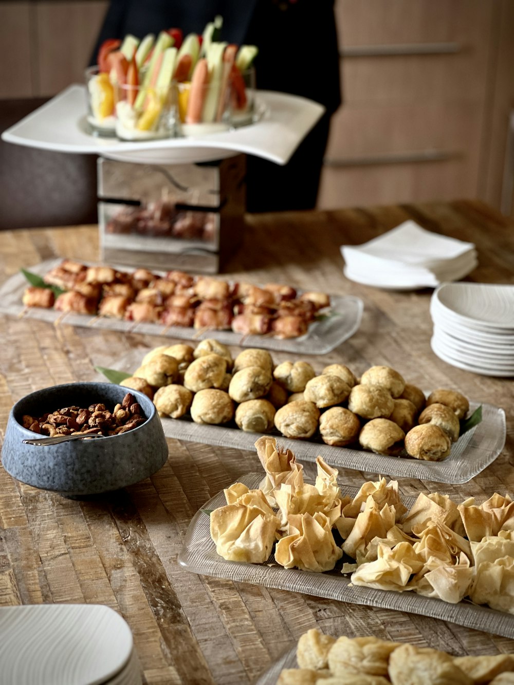 a wooden table topped with plates of food