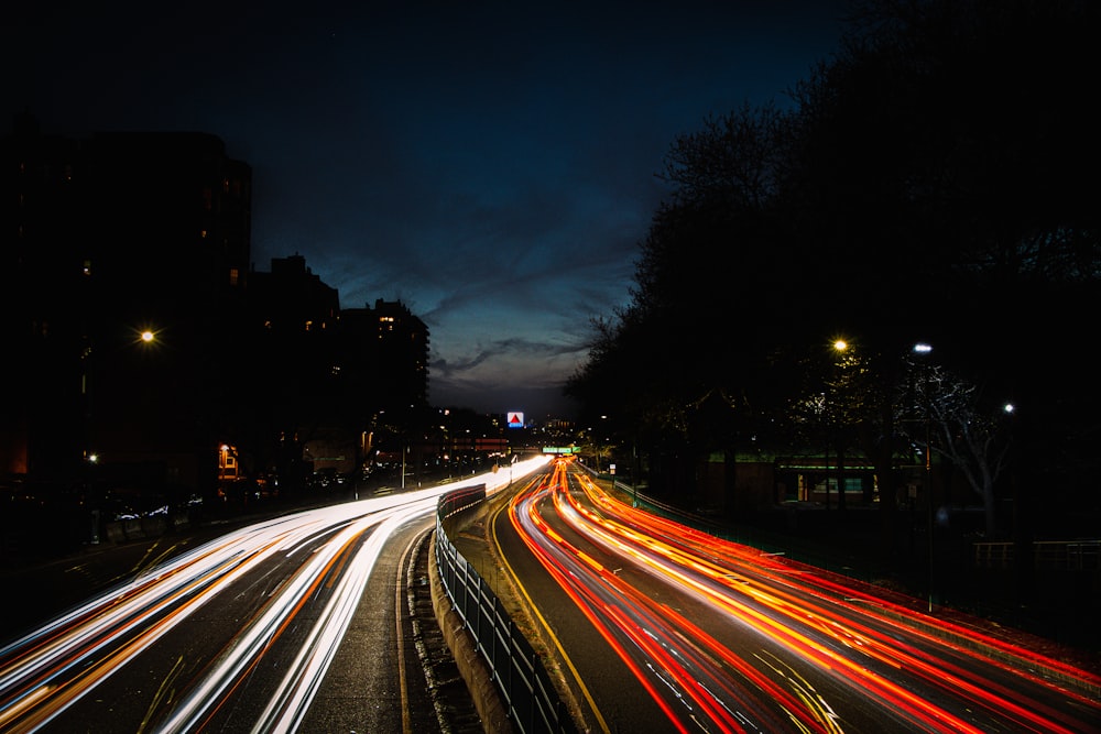 a city street filled with lots of traffic at night