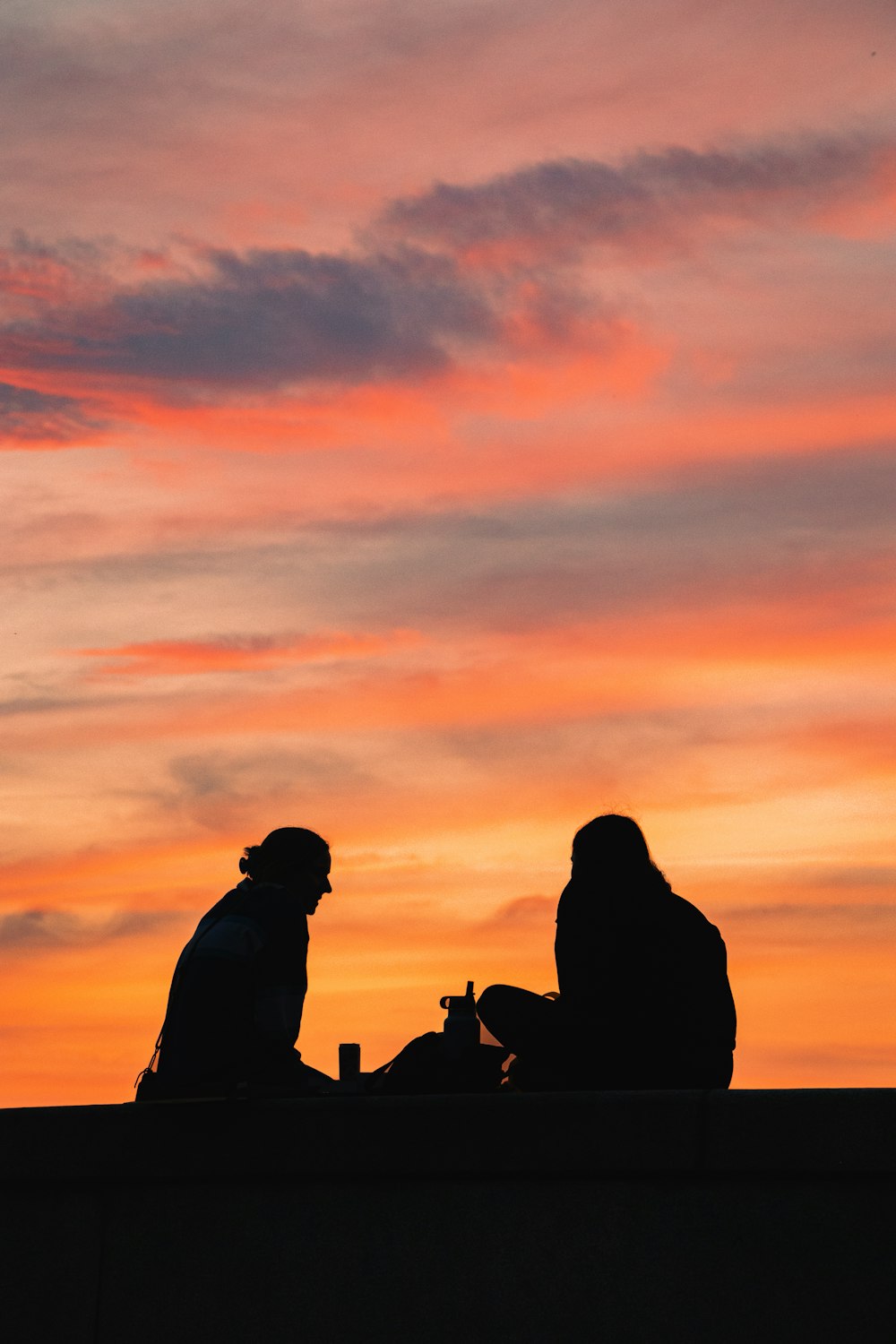 a couple of people sitting on top of a roof