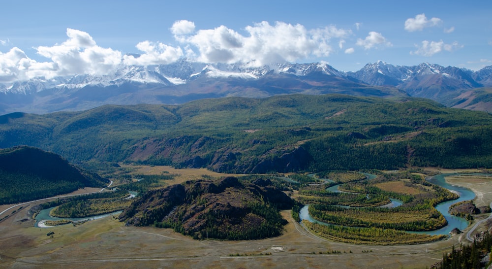 a view of a valley with mountains in the background