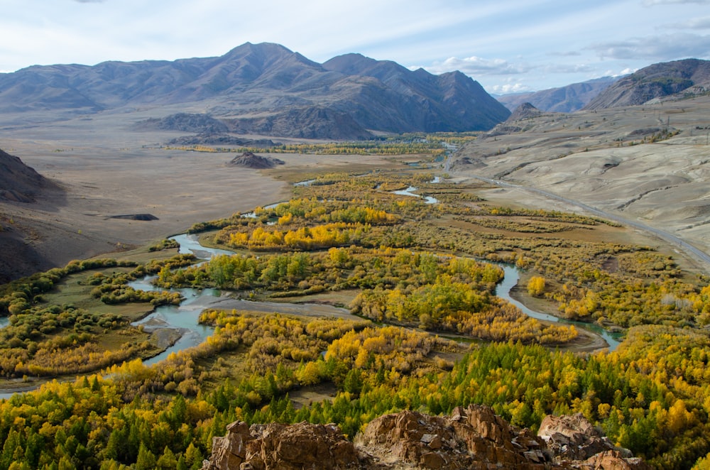 a river running through a valley surrounded by mountains