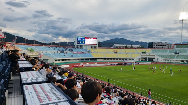 A lively soccer match between two historic teams on a sunny field.