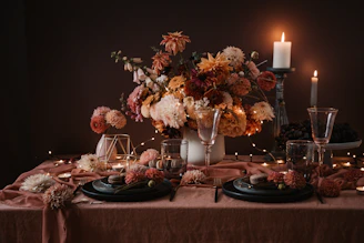 A beautifully arranged dining table with candles and delicate flower arrangements for the wedding dinner.