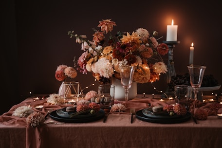 A beautifully styled table setting with soft floral arrangements and elegant tableware.