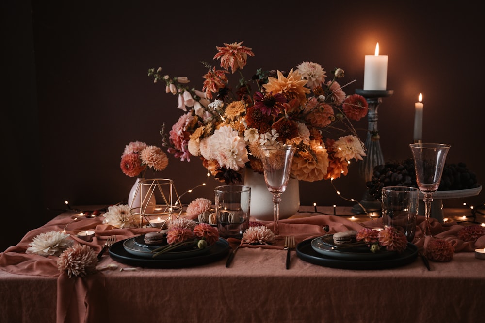 a table topped with a vase filled with flowers