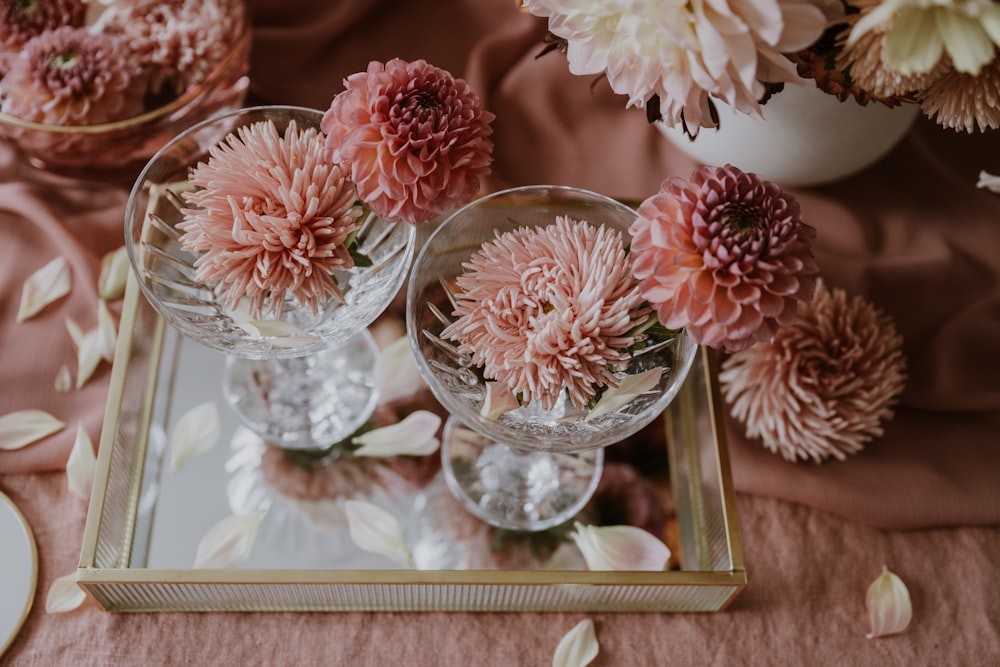 a table topped with vases filled with pink flowers