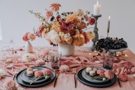 A beautiful table setting with pastries and flowers.