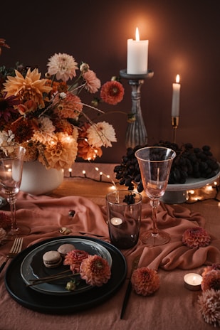An elegant table setting featuring wedding favors in warm brown and orange tones.