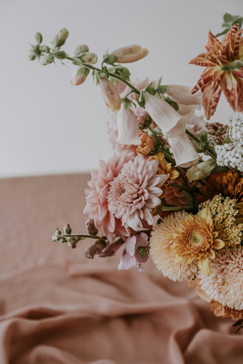 a bouquet of flowers sitting on top of a bed