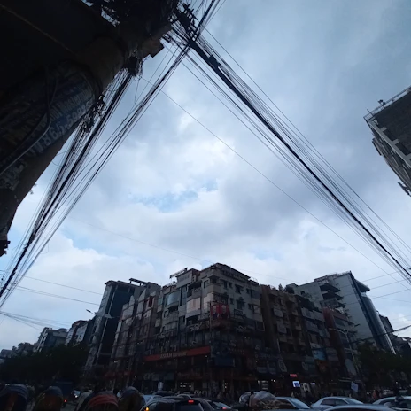 Wide shot of a busy urban street with ConnectPro technicians installing new cables overhead.
