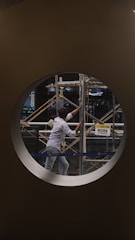 A construction site with scaffolding and a caution sign indicating work in progress.