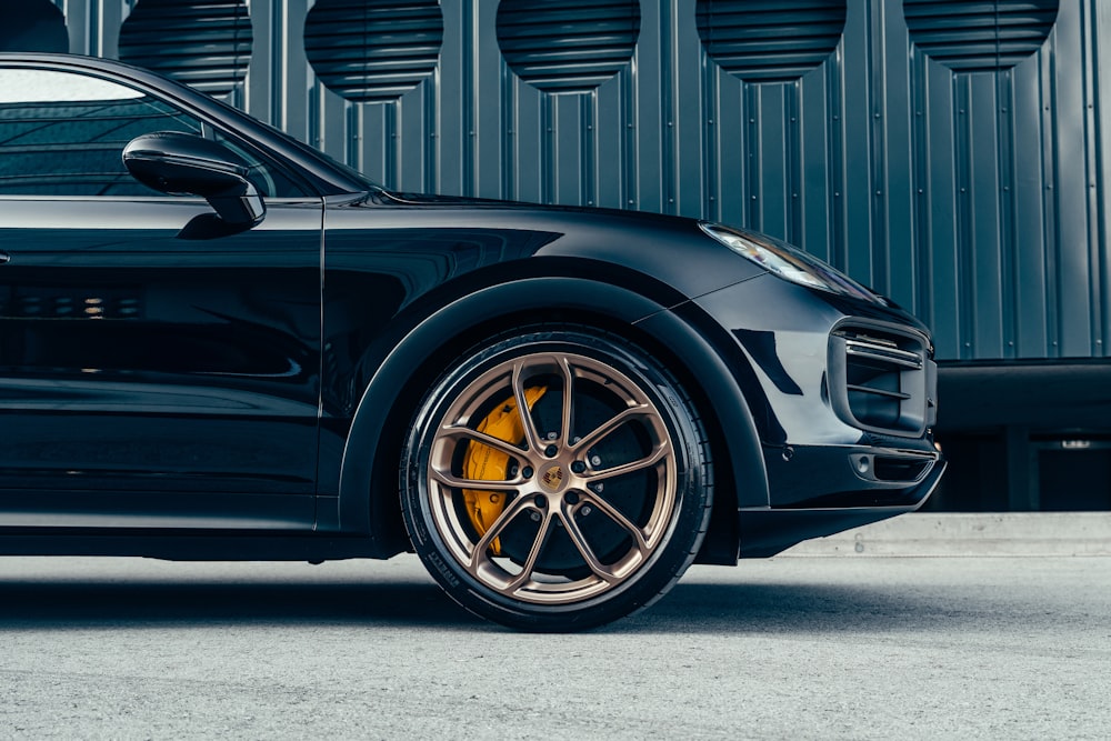 a black sports car parked in front of a building