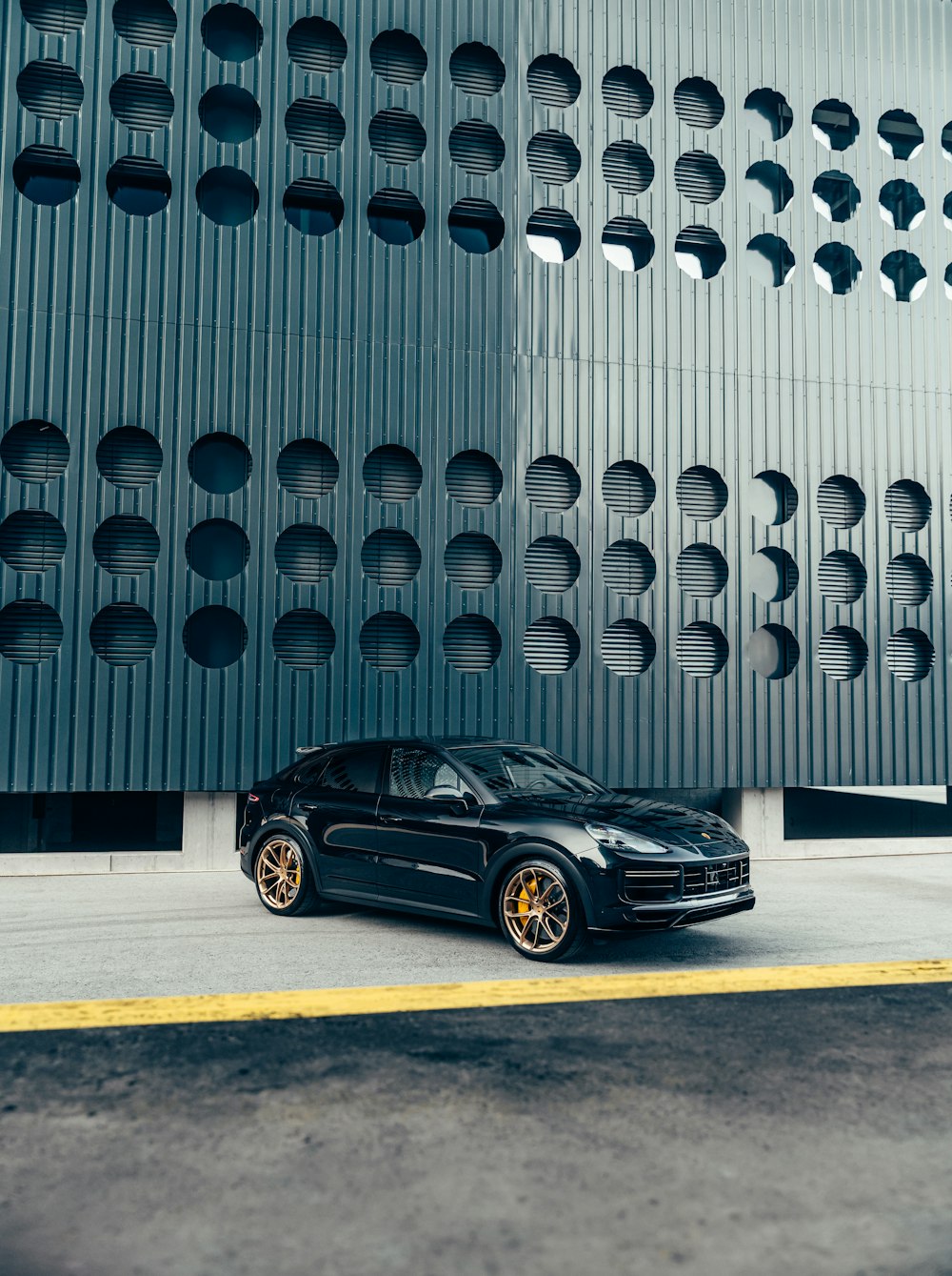 a black sports car parked in front of a building