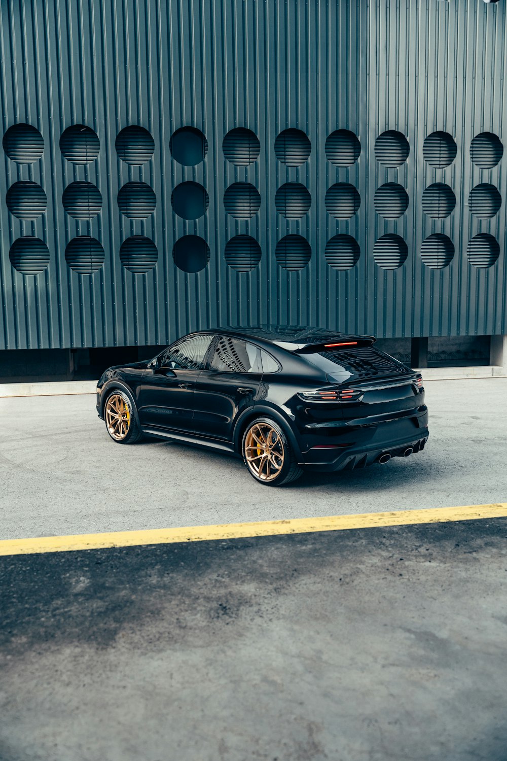 a black sports car parked in front of a building