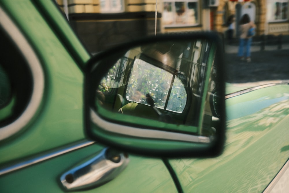 a rear view mirror on a green car