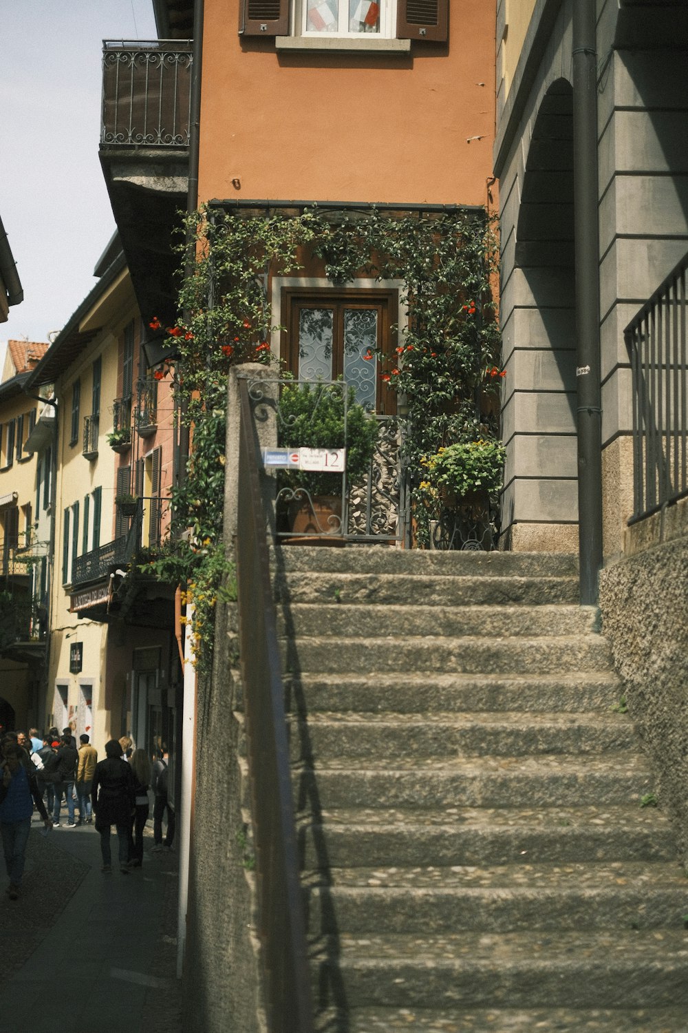 a group of people walking down a street next to a building