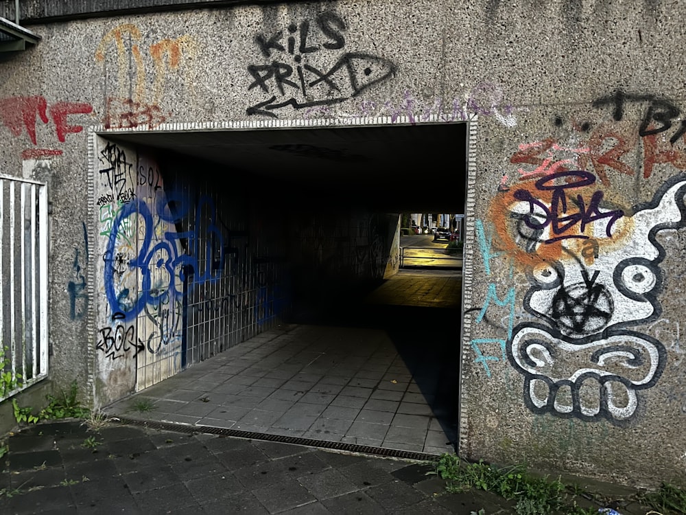 a tunnel with graffiti all over it