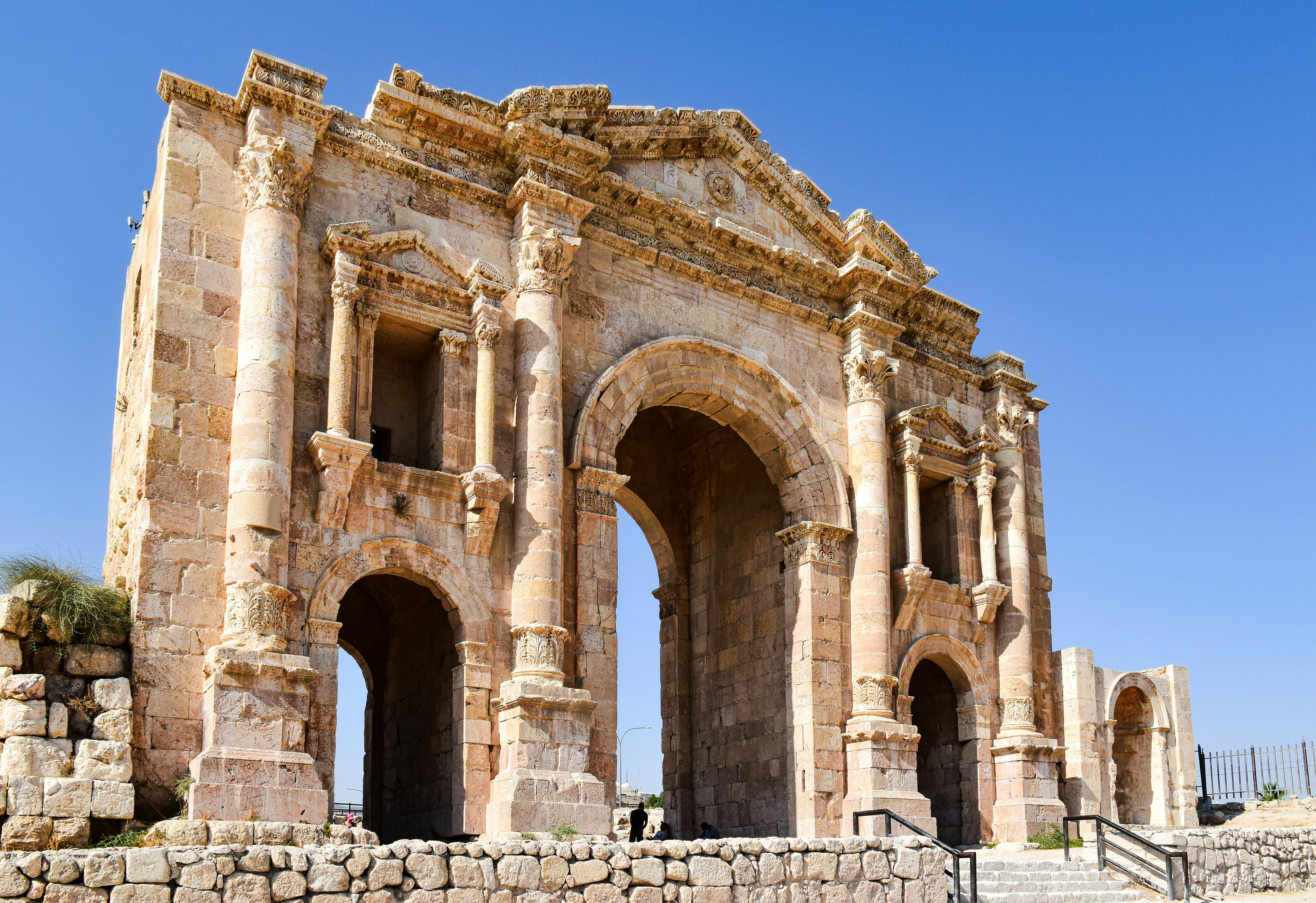 a large stone structure with two archways, Jerash, Jordan.