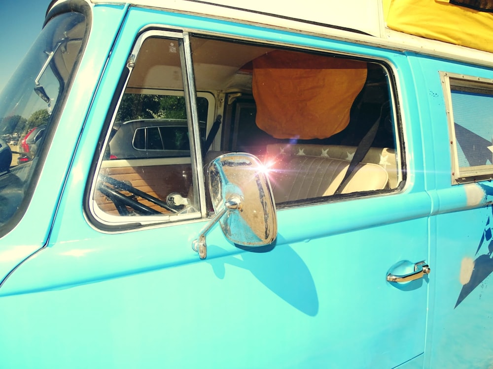 a blue van with a yellow tarp on top of it