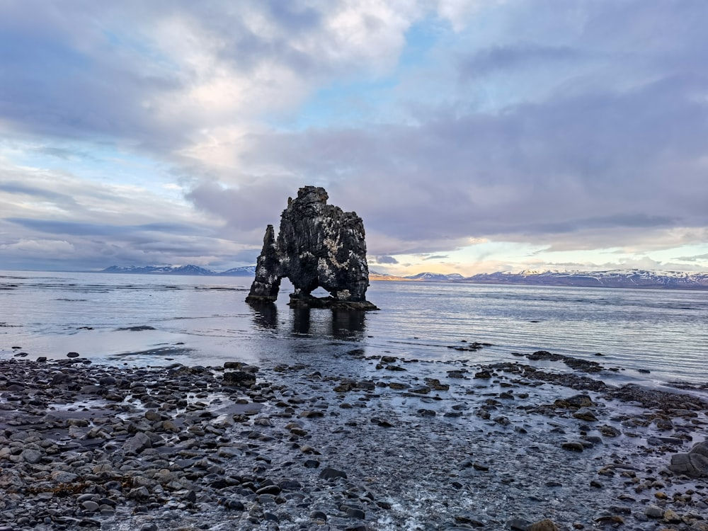 a rock formation in the middle of a body of water