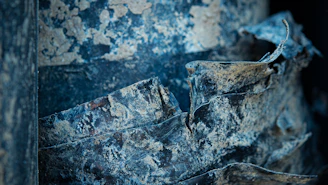 Close-up of textured paint layers blending earthy tones from a seaside view