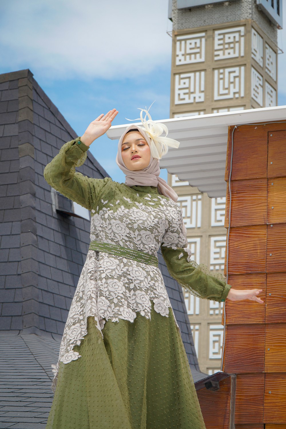 a woman in a green and white dress and a clock tower in the background