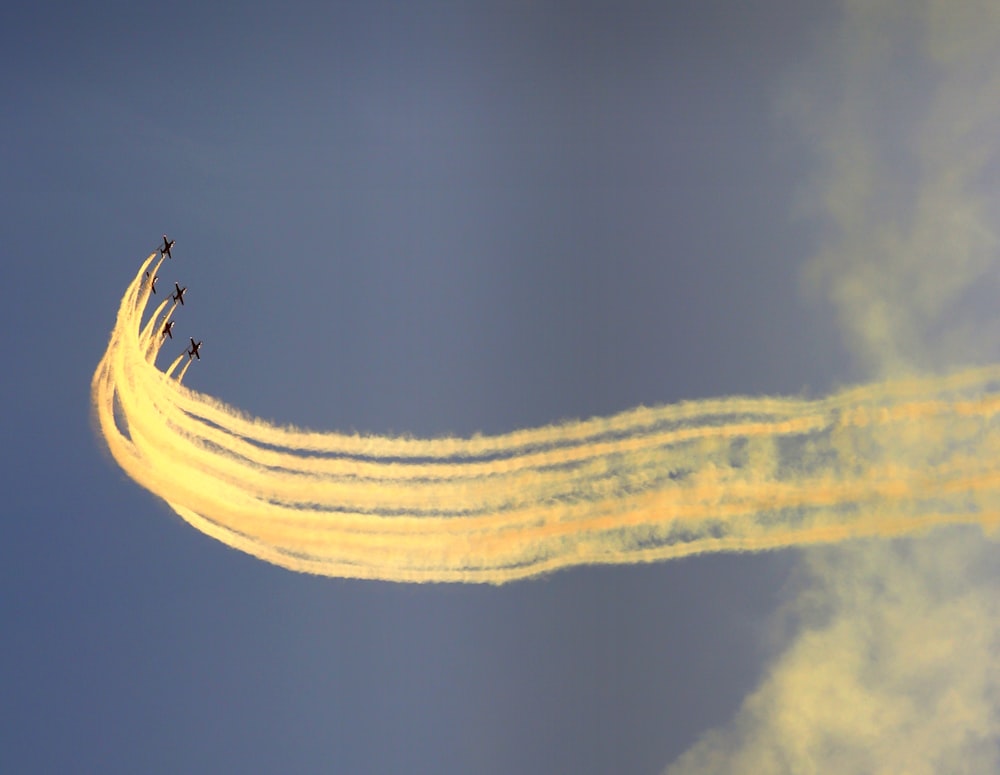 a group of airplanes flying through a blue sky