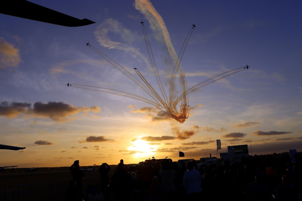 a group of airplanes flying through a cloudy sky