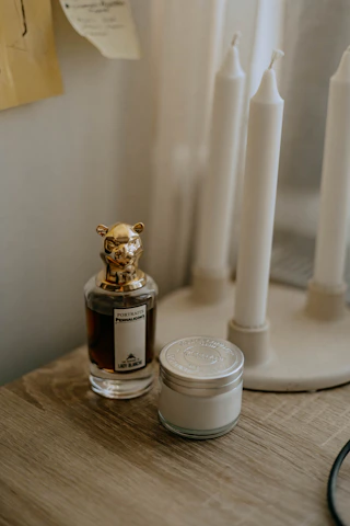 Artisan carefully crafting a perfume blend in a softly lit workshop.