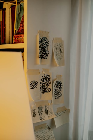A quiet corner of the atelier with sketches pinned on a corkboard.
