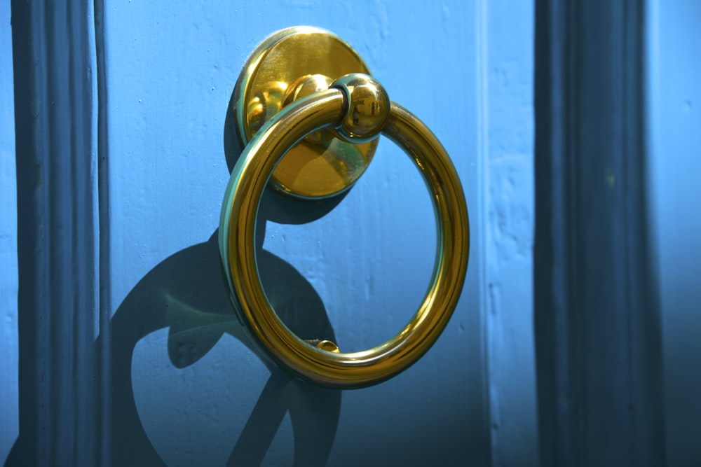 a golden door handle on a blue door