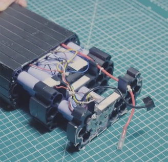 Close-up of a sleek Voltren lithium-ion battery module with glowing blue status indicators.