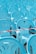 An array of light blue plastic chairs is neatly arranged in rows, possibly for an outdoor event. A red and white tape runs across one of the rows, suggesting a boundary or restricted area.