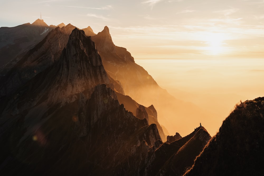 a person standing on the top of a mountain