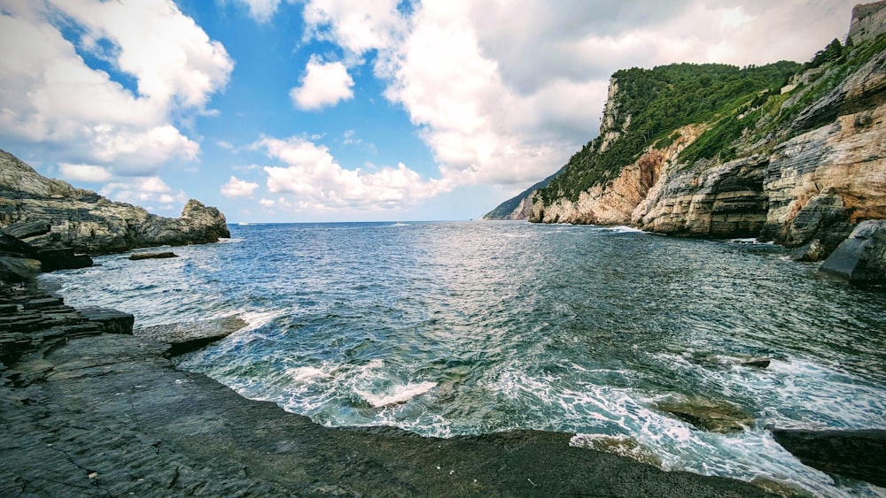 a body of water surrounded by rocky cliffs