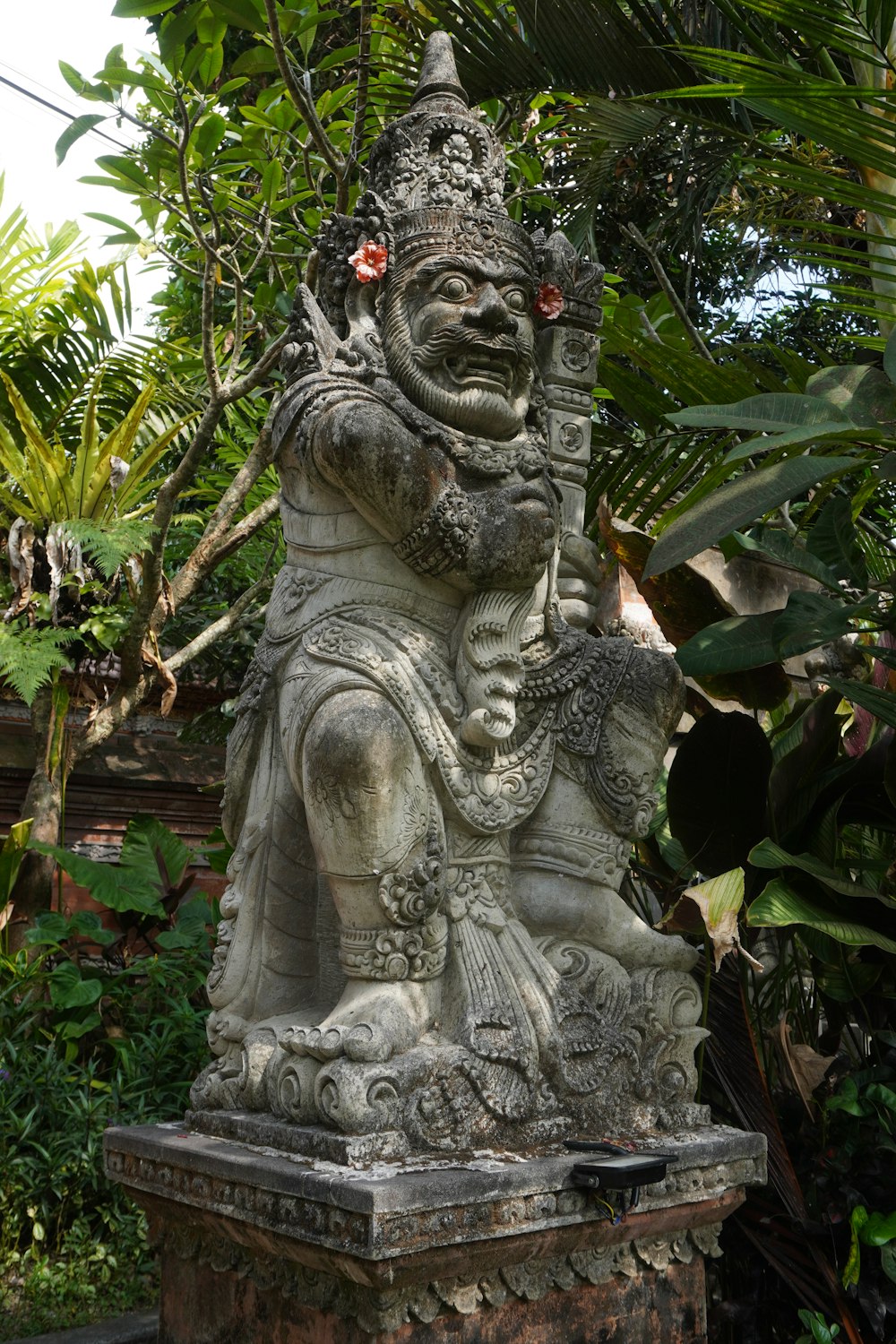 a statue of a demon holding a sword