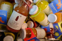 Close-up of vibrant, freshly squeezed fruit juices in clear bottles showcasing natural colors.
