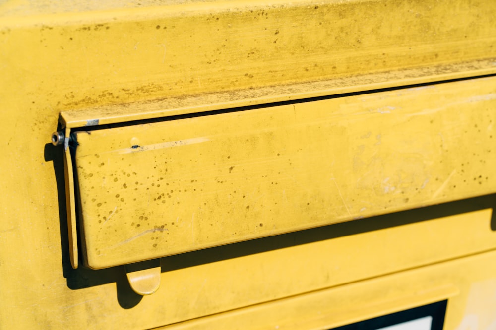 a close up of a yellow metal drawer