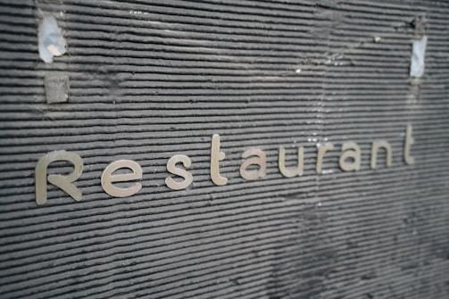 3D raised letters signage installed on a restaurant facade.