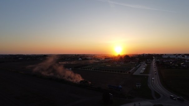A scenic view of a farm during sunset.