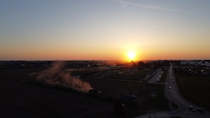 A scenic view of the rural landscape at sunset.