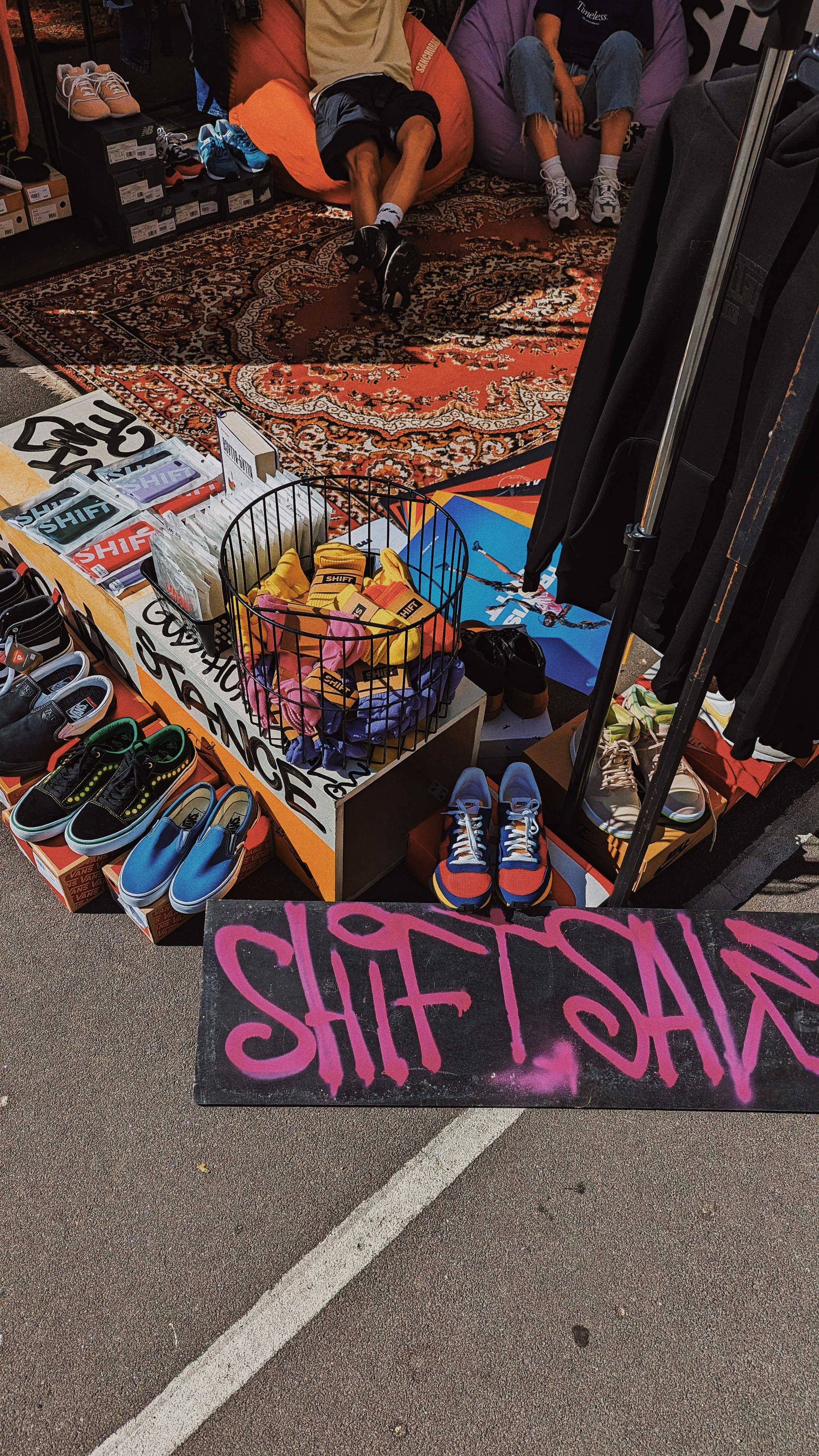 a display of shoes and umbrellas on a street