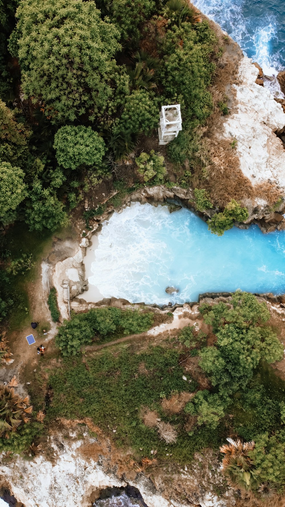 an aerial view of a body of water surrounded by trees