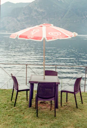 Outdoor patio setup with elegant chairs and a folding tent.